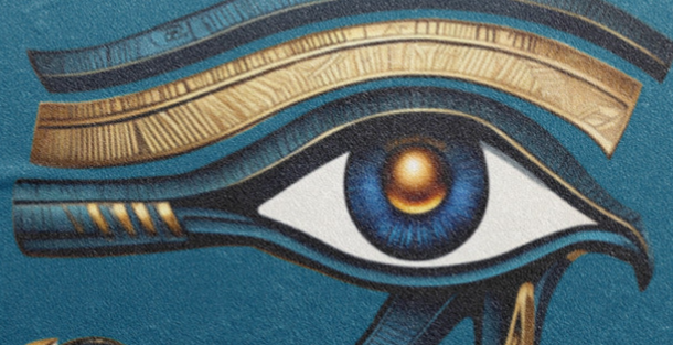 Beach towel with eye symbol design with gold and blue on a textured blue background
