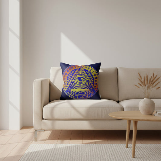 Decorative pillow with a geometric design on a beige sofa in a living room setting.